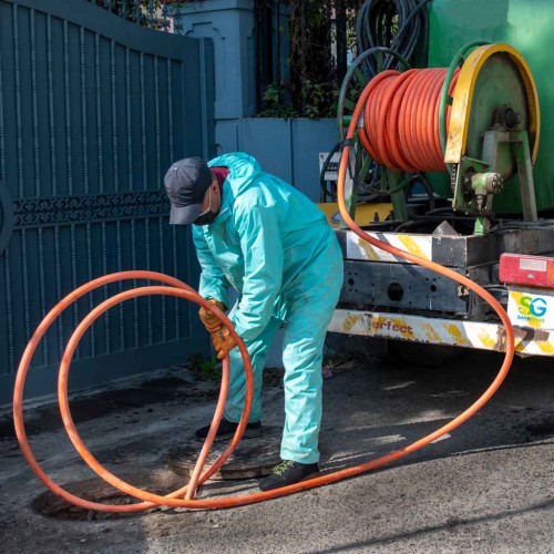 a man unblocking sewage drain by hydro jetting