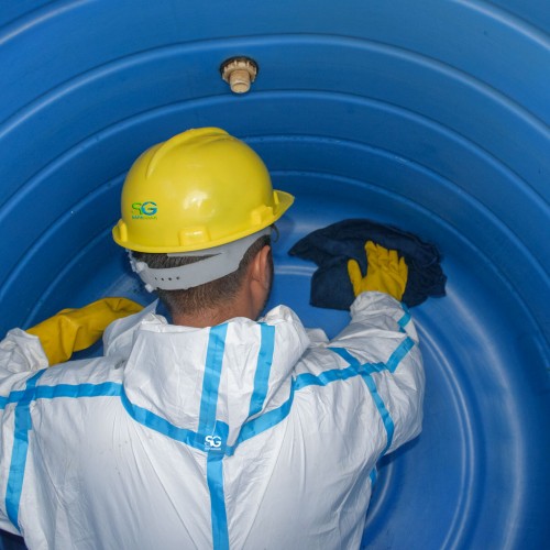 a man cleaning water tank